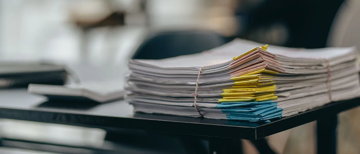 stack of papers on desk