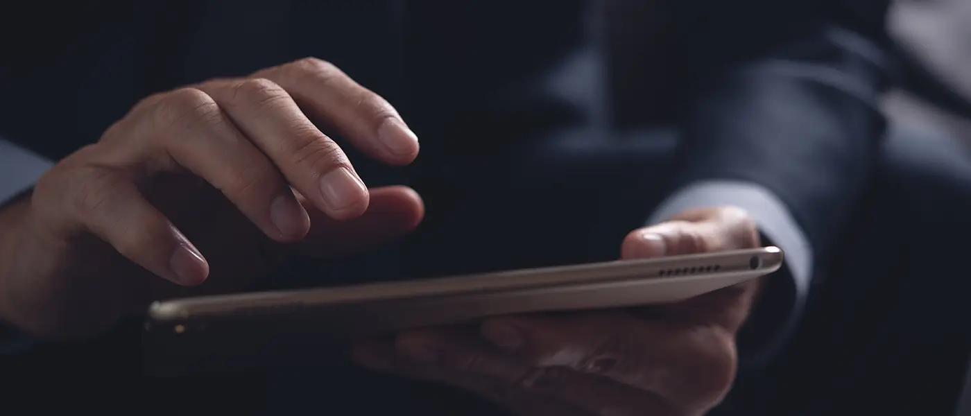 person scrolling on tablet